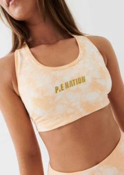 P.E Nation | React Sports Bra - Golden Sand -Fashion Clothing Store PENATION Q2 APR22 MAY22 TASH GALGUT S07 098 800x 0de96bce 9322 4e30 b2ca f4561cda2cf8